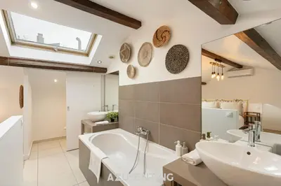 a bathroom with a large tub and a sink at Azurenting - Maison Césario - 3 chambres in Cannes