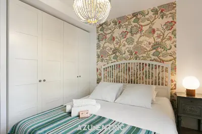 a small bedroom with a bed and a wallpaper at Azurenting - Maison Césario - 3 chambres in Cannes