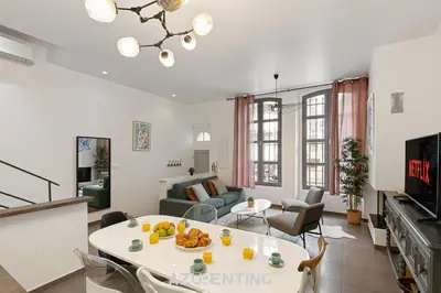 a living room with a couch and a table at Azurenting - Maison Césario - 3 chambres in Cannes