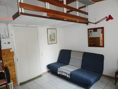 a living room with a blue couch in a room at PROMO! Studio, Plein Center, Vieux Port, 200 m des plages in Cannes