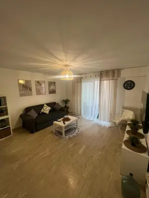 a living room with a couch and a table at Logements centrale in Cannes