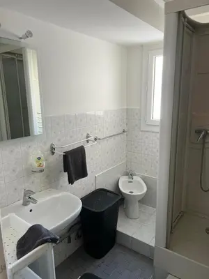 a white bathroom with a sink and a toilet at Logements centrale in Cannes