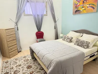 a bedroom with a bed and a window at T3 Cannes Banane in Cannes