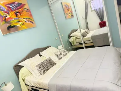 a bedroom with a bed and a mirror at T3 Cannes Banane in Cannes