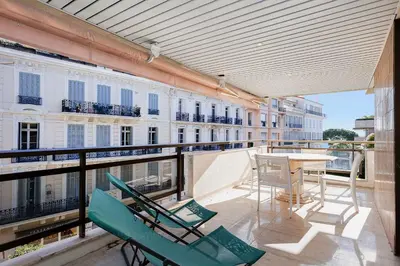 a balcony with chairs and a table on a balcony at GRAY 3e1 in Cannes