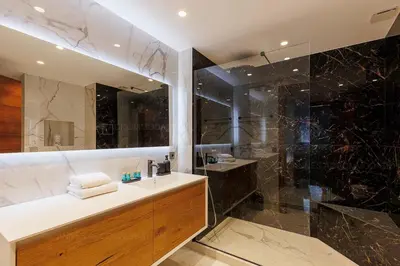 a bathroom with a toilet and a wooden door at GRAY 3e1 in Cannes