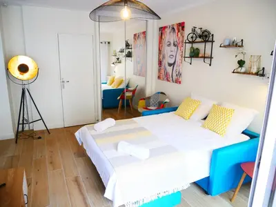 a bedroom with a blue and white bed in a room at Sublime apartment 100 m from the Croisette in Cannes