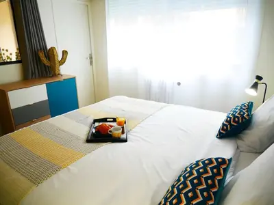 a bed with a tray of fruit on it at Sublime apartment 100 m from the Croisette in Cannes