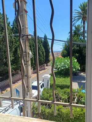 a window with a view of a street at Maison palm in Cannes