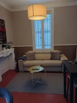 a living room with a couch and a table at Maison palm in Cannes