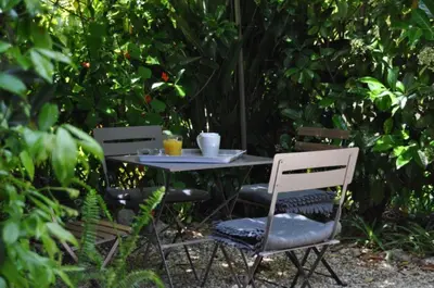 a table with two chairs and two cups on it at Maison palm in Cannes