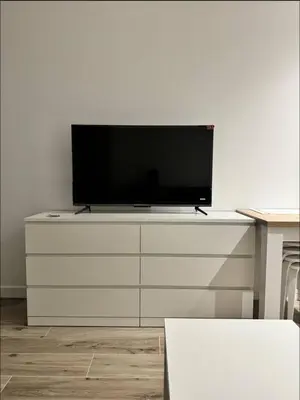 a television on top of a white dresser at Studios Cannes Les 3 éléments in Cannes