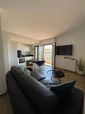 a living room with a couch and a table at 2 pièces vue sur le Suquet in Cannes