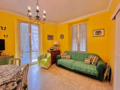 a living room with a green couch and yellow walls at 3 Pièces à 100m de la Croisette in Cannes