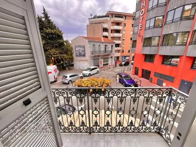 a balcony with a view of a city street with cars at 3 Pièces à 100m de la Croisette in Cannes