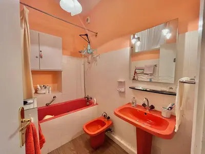 a bathroom with a red sink and a red toilet at 3 Pièces à 100m de la Croisette in Cannes