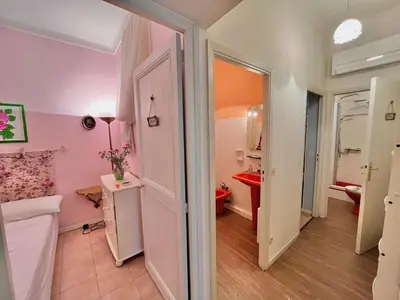a bathroom with a pink room with a red sink at 3 Pièces à 100m de la Croisette in Cannes