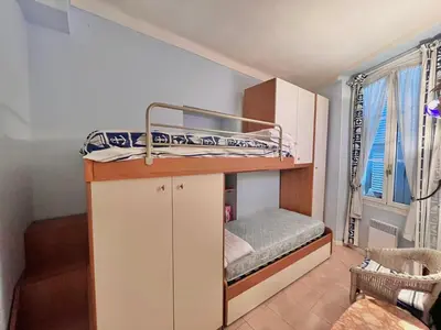 a small bunk bed in a room with a window at 3 Pièces à 100m de la Croisette in Cannes