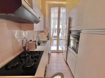 a kitchen with a stove top oven next to a sink at 3 Pièces à 100m de la Croisette in Cannes