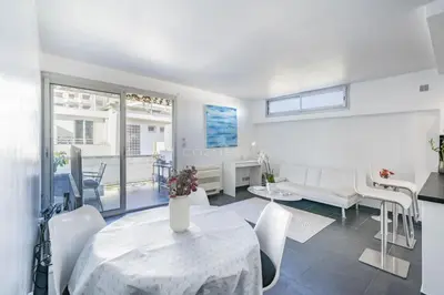 a living room with a white table and chairs at Rooftop La Croisette Cannes in Cannes