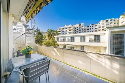 a balcony with a table and a view of a building at Rooftop La Croisette Cannes in Cannes