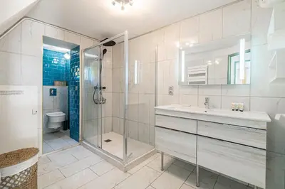 a bathroom with a shower and a sink and a toilet at LA VILLA DES FLEURS en duplex avec jardin et piscine in Le Cannet