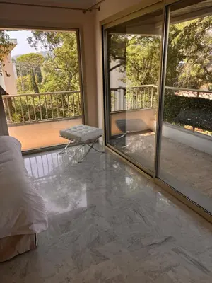 a room with a bed and a balcony with sliding glass doors at Appart exceptionnel terrasse mer in Cannes