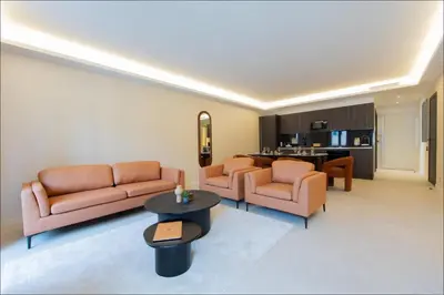 a living room with a white couch and a table at Hôtel particulier Marceau - Centre - Neuf - Suites de 3 à 28 chambres in Cannes