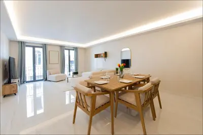 a kitchen and dining room with a table and chairs at Hôtel particulier Marceau - Centre - Neuf - Suites de 3 à 28 chambres in Cannes
