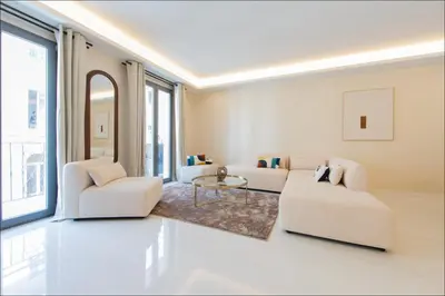 a living room and kitchen with a table and chairs at Hôtel particulier Marceau - Centre - Neuf - Suites de 3 à 28 chambres in Cannes