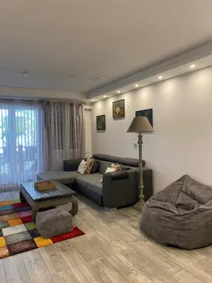 a living room with a couch and a table at Pretty flat in Cannes