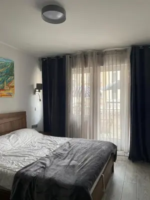 a bedroom with a bed and a large window at Pretty flat in Cannes