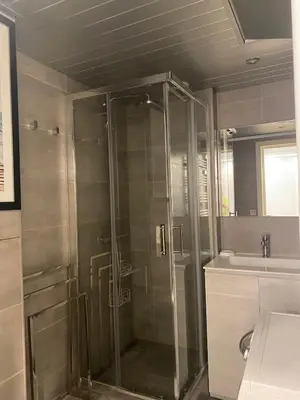 a shower with a glass door in a bathroom at Pretty flat in Cannes
