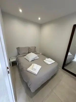a bedroom with a bed with two towels on it at Appartement terrasse Cannes Suquet proche plage et centre in Cannes
