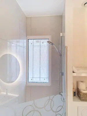 a bathroom with a shower and a window at Appartement terrasse Cannes Suquet proche plage et centre in Cannes