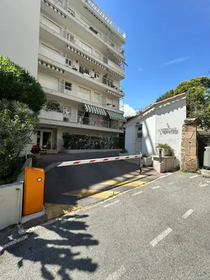 an empty street with a large building in the background at Appartement terrasse Cannes Suquet proche plage et centre in Cannes