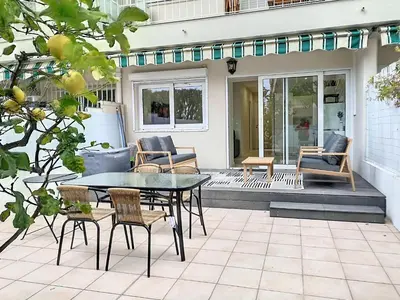 a patio with a table and chairs on a porch at Appartement terrasse Cannes Suquet proche plage et centre in Cannes