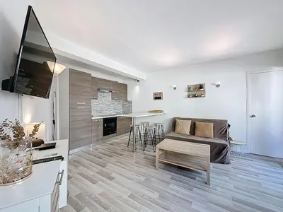 a living room with a couch and a table at Rivieira - By Coco in Cannes