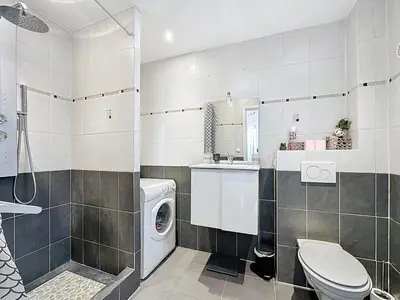 a bathroom with a washing machine and a washer at Rivieira - By Coco in Cannes