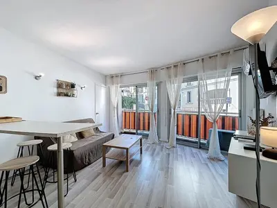 a living room with a bed and a table in a room at Rivieira - By Coco in Cannes