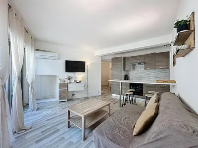 a living room with a couch and a table at Rivieira - By Coco in Cannes