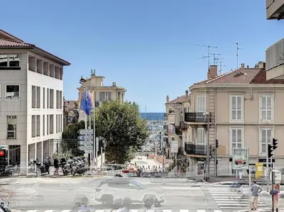a city intersection with a white car on a street at Rivieira - By Coco in Cannes