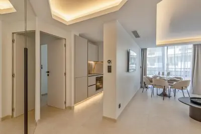 a kitchen and dining room with a table and chairs at 2 Appartements porte à porte Groupe & famille in Cannes
