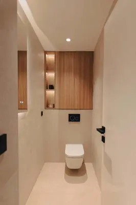 a bathroom with a toilet and wooden cabinets at 2 Appartements porte à porte Groupe & famille in Cannes