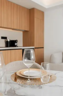 a table with two wine glasses and a plate on it at 2 Appartements porte à porte Groupe & famille in Cannes