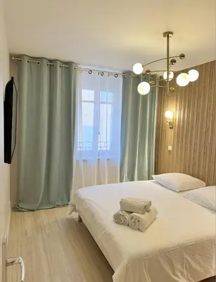 a bedroom with a bed with towels on it at Elegant old port apartment in Cannes