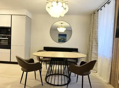 a dining room with a table and chairs at Elegant old port apartment in Cannes