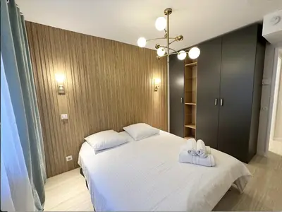 a bedroom with a white bed with towels on it at Elegant old port apartment in Cannes