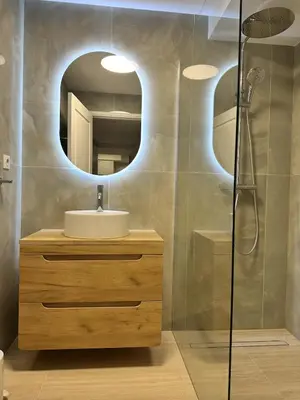 a bathroom with a sink and a mirror at Elegant old port apartment in Cannes