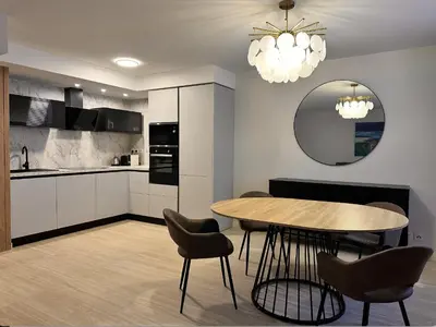 a kitchen with a table and chairs and a mirror at Elegant old port apartment in Cannes